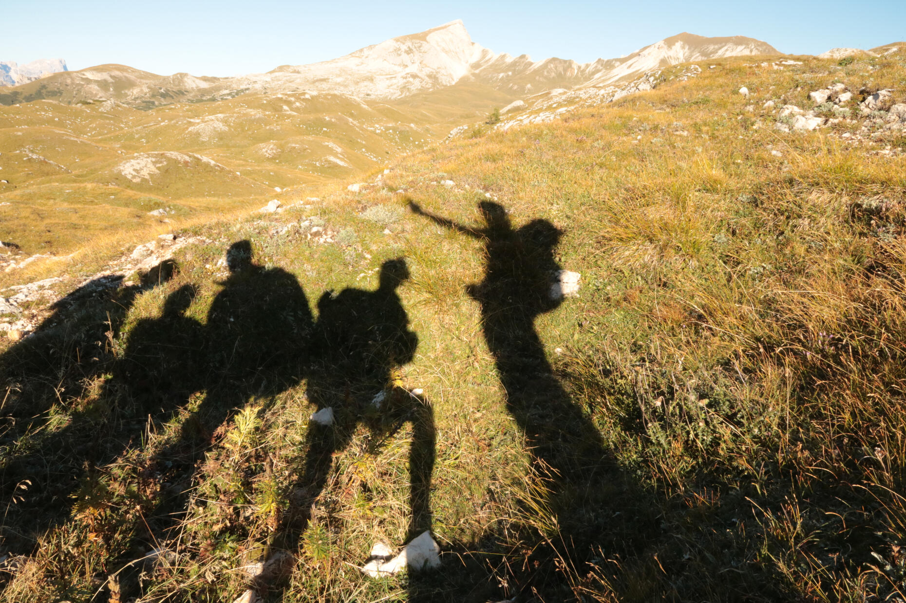 Shadow of people in the mountain showing the way to go